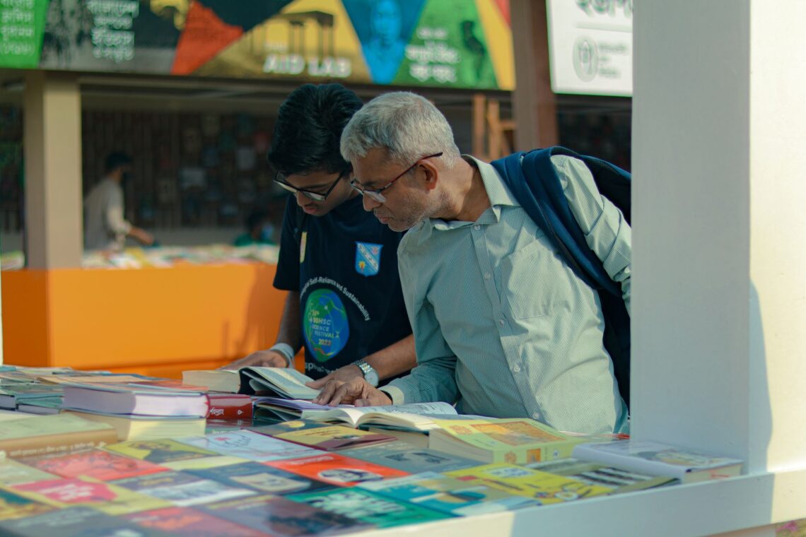 people browsing books at an outdoor marketplace