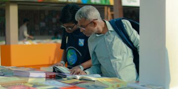 people browsing books at an outdoor marketplace